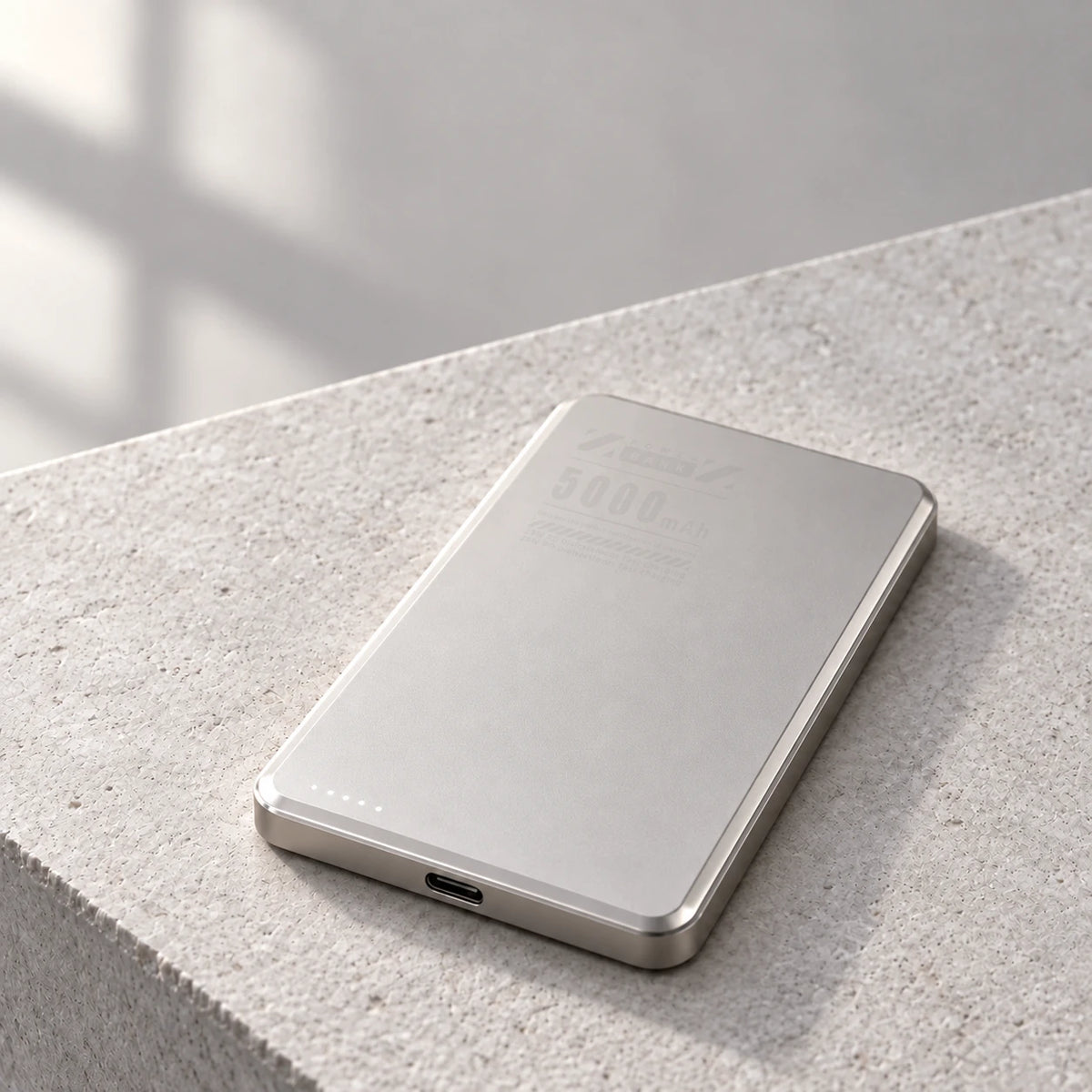 Gray aluminum 5000mAh power bank showing its thin body and USB-C port.