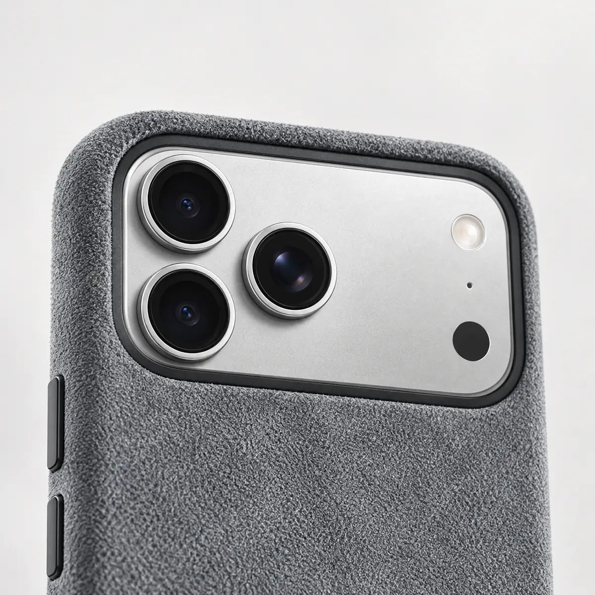 Close view of the raised gray fabric case rim around a silver phone camera.