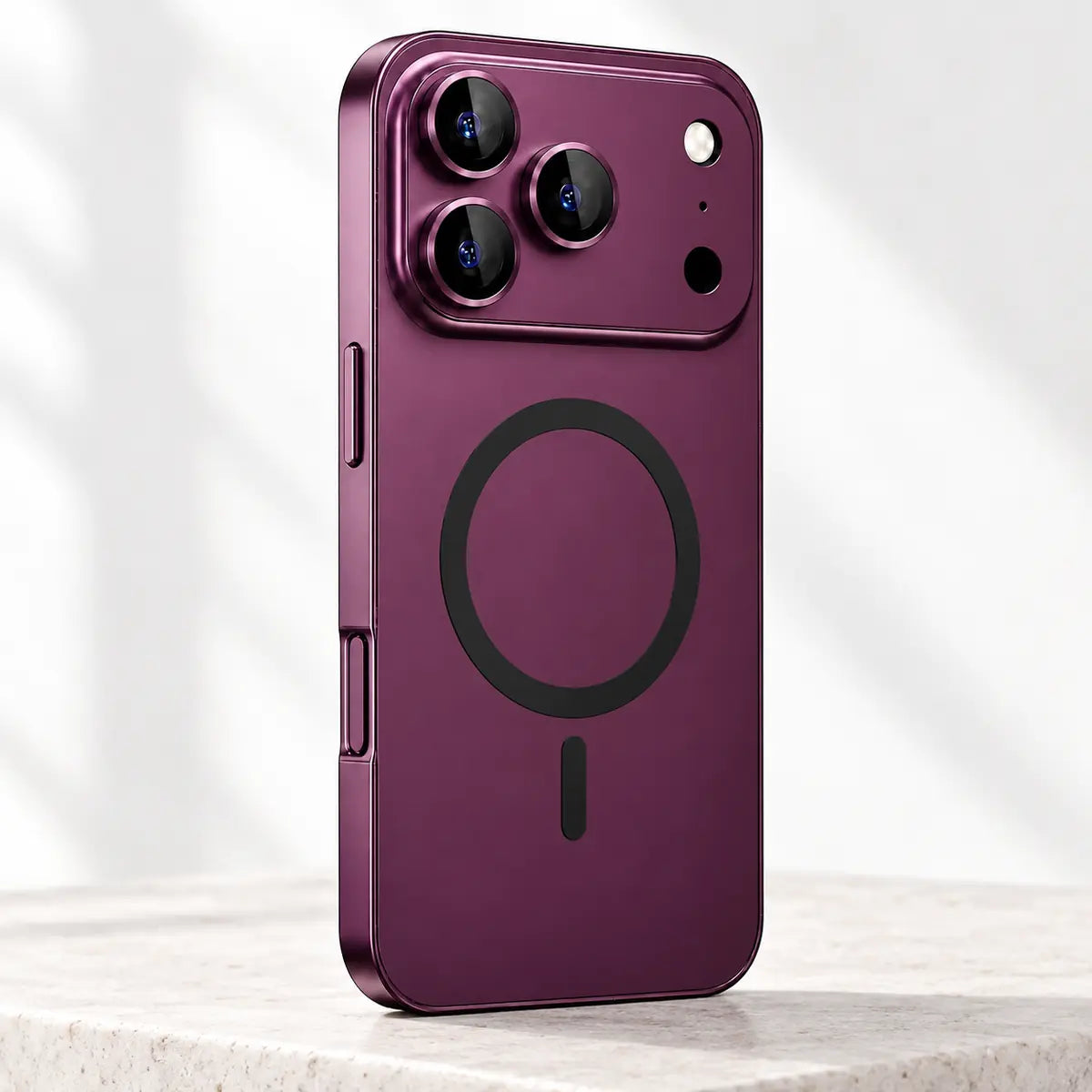 Burgundy metal-frame magnetic iPhone case in a bright studio setting