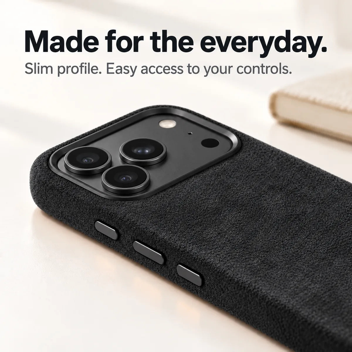 Black fabric phone case with a close view of its slim side and controls. #color_Midnight Black