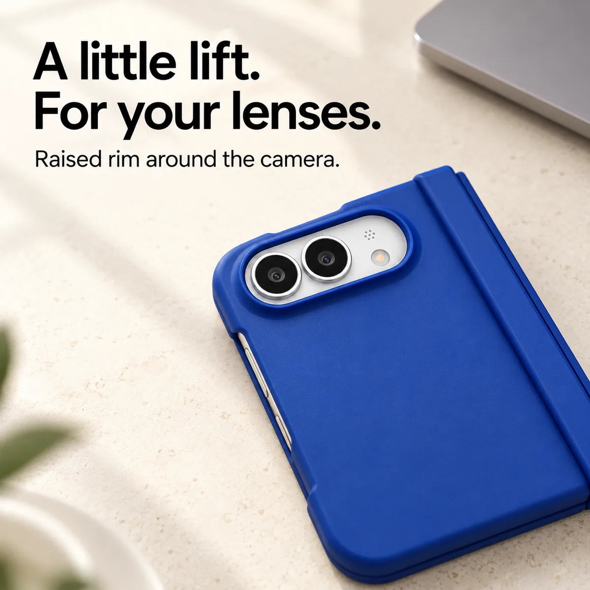 Close-up of the raised Blue camera rim on a matte iPhone Ultra case resting on a light desk. #color_Cobalt Blue