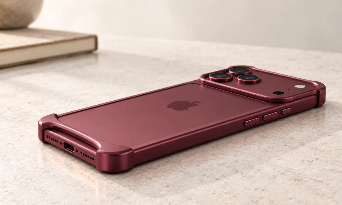Low side view of a Burgundy phone with a slim metal bumper, exposed side buttons and raised camera guard.