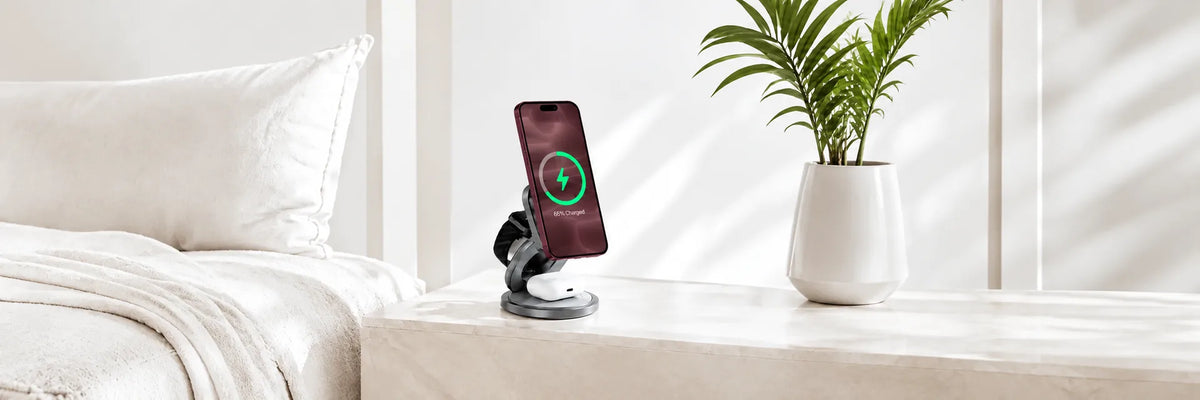 Foldable wireless charging station with a burgundy phone, watch and earbuds.