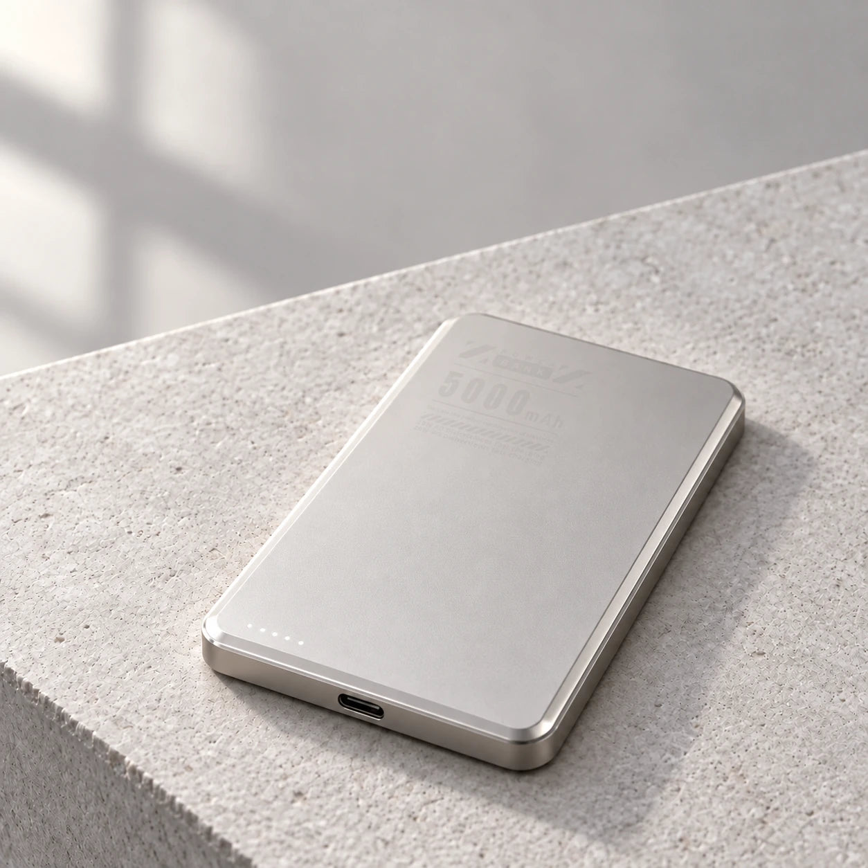 Gray aluminum 5000mAh power bank showing its thin body and USB-C port.
