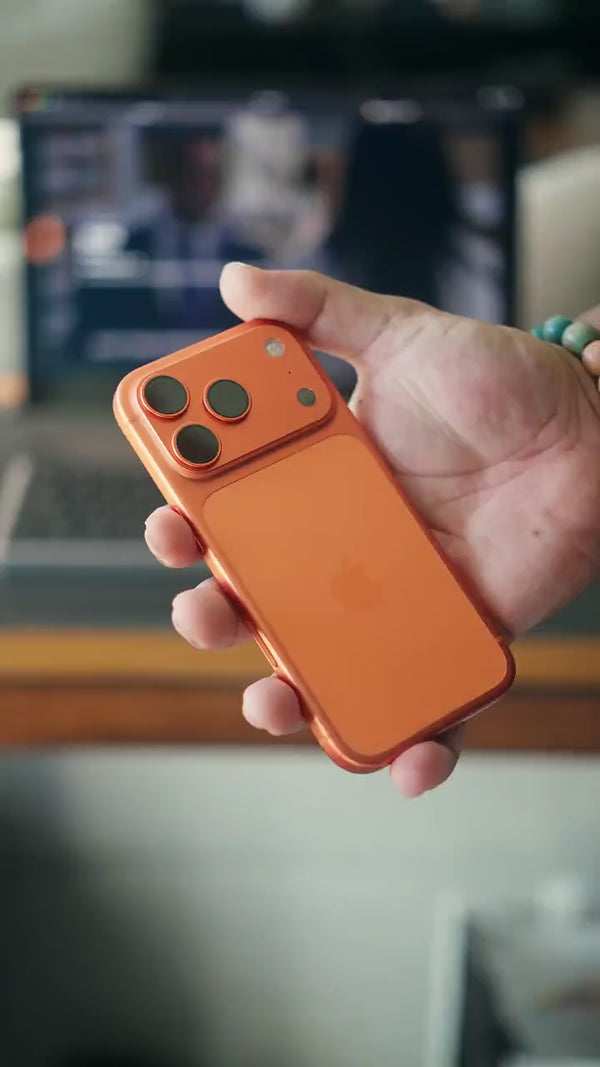 MagBank Qi2 Slim magnetic power bank — snapping onto an iPhone for aligned wireless charging